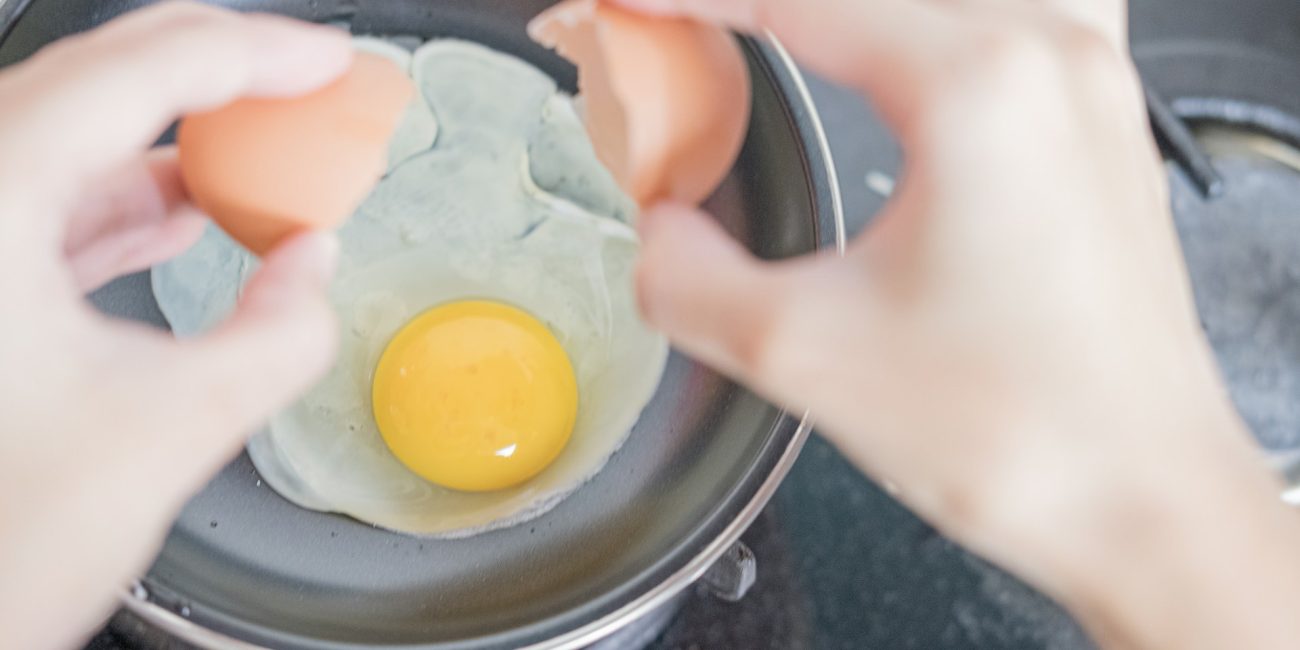 Person cooking eggs